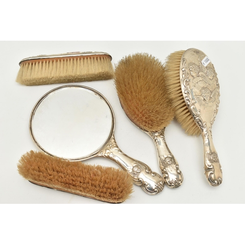 110 - FIVE SILVER VANITY ITEMS, to include a hand held mirror and two hair brushes, embossed cherubs and f... 