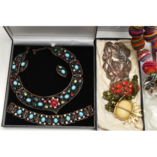 131 - A LARGE BOX OF ASSORTED COSTUME JEWELLERY, to include a rolled gold buckle bangle, a coral gold plat... 