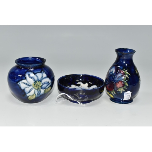 377 - THREE SMALL PIECES OF BLUE GROUND MOORCROFT POTTERY, comprising a shallow footed bowl decorated with... 