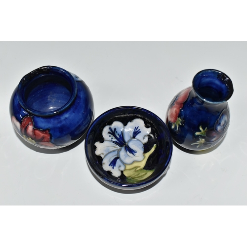 377 - THREE SMALL PIECES OF BLUE GROUND MOORCROFT POTTERY, comprising a shallow footed bowl decorated with... 