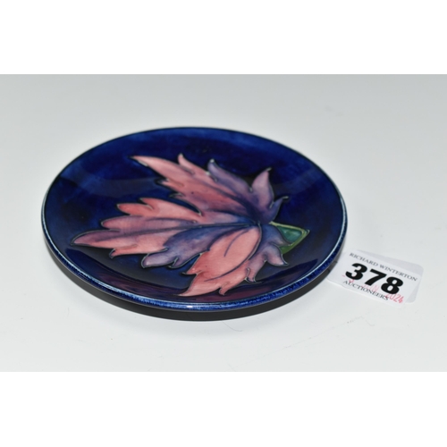 378 - A MOORCROFT POTTERY BLUE GROUND PIN DISH / COASTER, decorated with a Maple leaf design, impressed an... 