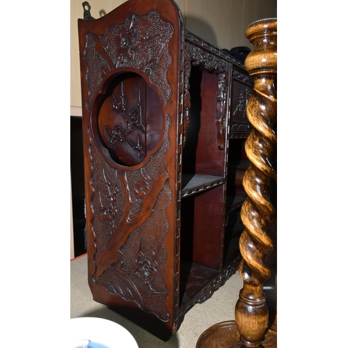 405 - AN ORIENTAL CARVED WALL DISPLAY CABINET,  carved dark wood cabinet, decorated with a prunus blossom ... 