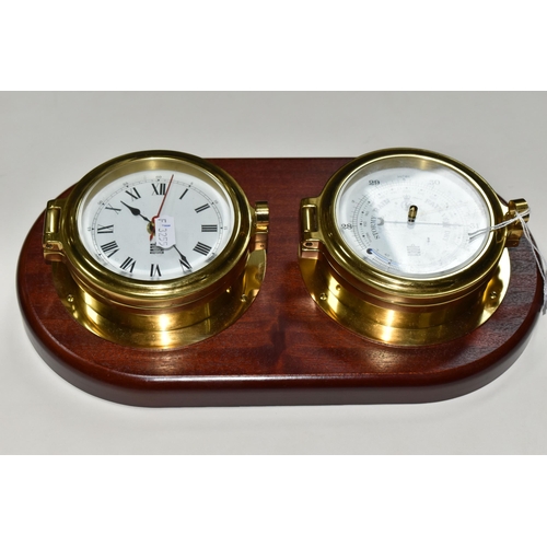 421 - A SEWILLS NAUTICAL STYLE WALL CLOCK AND BAROMETER,  a mahogany plaque set with a brass cased bulkhea... 