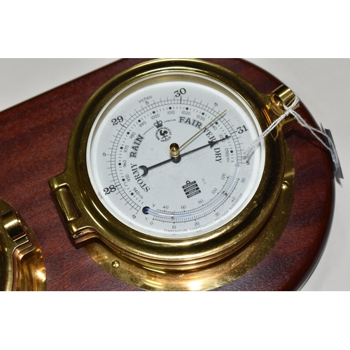 421 - A SEWILLS NAUTICAL STYLE WALL CLOCK AND BAROMETER,  a mahogany plaque set with a brass cased bulkhea... 