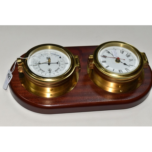 421 - A SEWILLS NAUTICAL STYLE WALL CLOCK AND BAROMETER,  a mahogany plaque set with a brass cased bulkhea... 