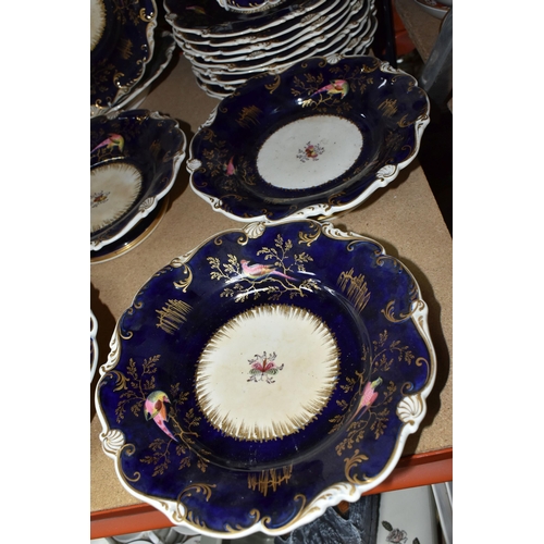 485 - A MID 19TH CENTURY ENGLISH PORCELAIN PART DESSERT SERVICE WITH COBALT BLUE GROUND, scrolled rim, the... 