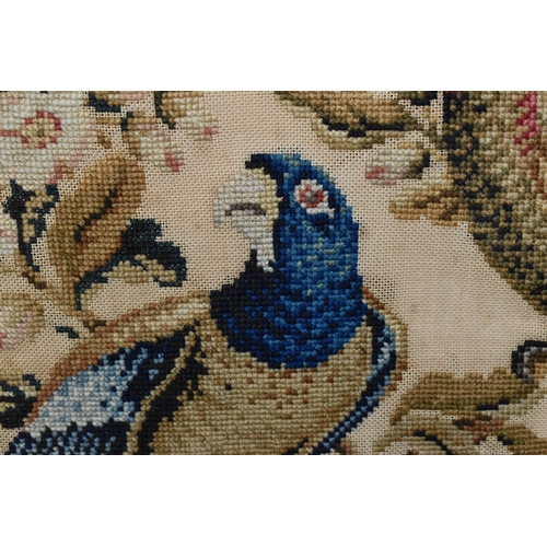 503 - TWO 19TH CENTURY NEEDLEWORK PICTURES, the first a tapestry worked in wool depicting two exotic birds... 