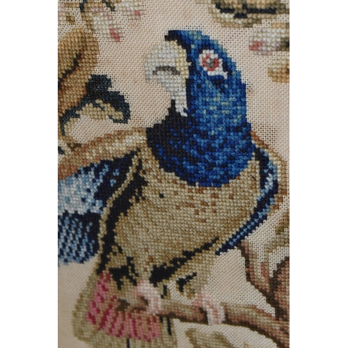 503 - TWO 19TH CENTURY NEEDLEWORK PICTURES, the first a tapestry worked in wool depicting two exotic birds... 