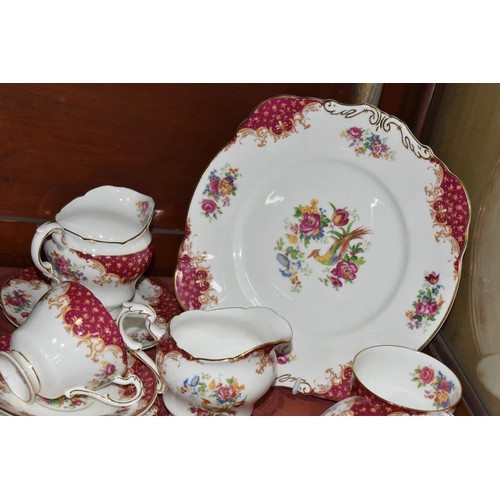 521 - A TWENTY TWO PIECE PARAGON 'ROCKINGHAM' PATTERN PART TEA SET, comprising a cake plate, two cream jug... 