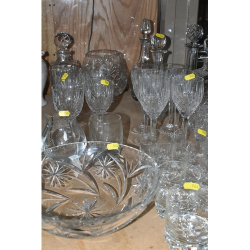 524 - A LARGE QUANTITY OF CUT CRYSTAL GLASSWARE to include five decanters, twelve wine glasses, fourteen w... 