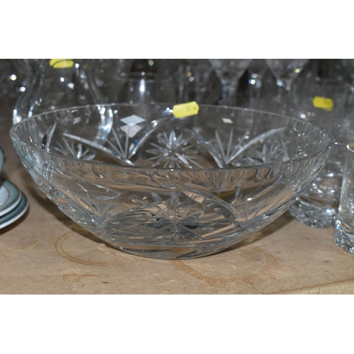 524 - A LARGE QUANTITY OF CUT CRYSTAL GLASSWARE to include five decanters, twelve wine glasses, fourteen w... 