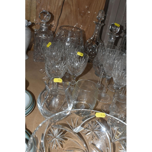 524 - A LARGE QUANTITY OF CUT CRYSTAL GLASSWARE to include five decanters, twelve wine glasses, fourteen w... 