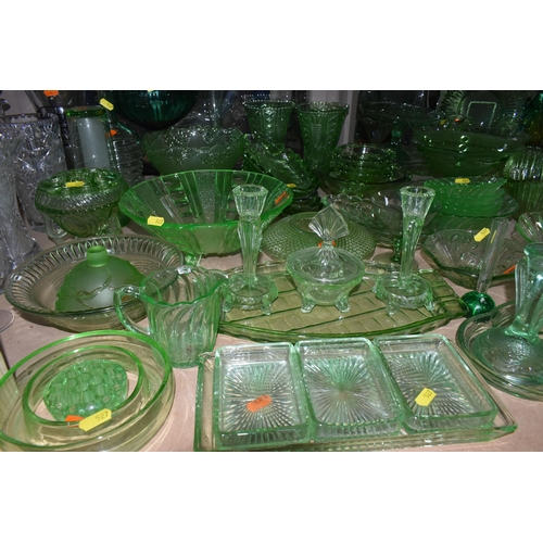 527 - A LARGE QUANTITY OF GREEN GLASSWARE to include assorted bowls and dishes, vases, candlesticks, trays... 