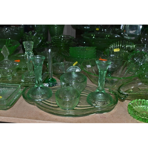 527 - A LARGE QUANTITY OF GREEN GLASSWARE to include assorted bowls and dishes, vases, candlesticks, trays... 