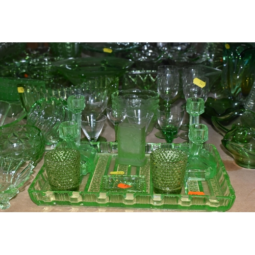 527 - A LARGE QUANTITY OF GREEN GLASSWARE to include assorted bowls and dishes, vases, candlesticks, trays... 