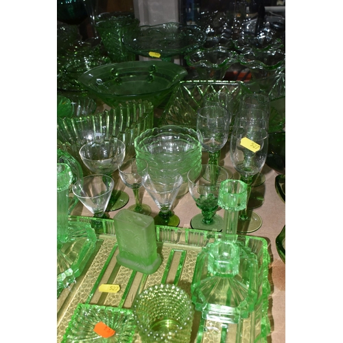 527 - A LARGE QUANTITY OF GREEN GLASSWARE to include assorted bowls and dishes, vases, candlesticks, trays... 