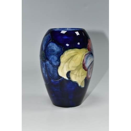 325 - A MOORCROFT POTTERY CLEMATIS PATTERN VASE, the ovoid vase tube lined with purple Clematis flowers on... 