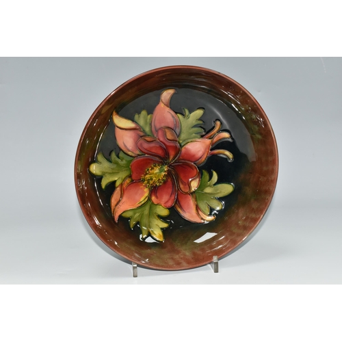 328 - A MOORCROFT POTTERY FLAMBÉ COLUMBINE PATTERN BOWL, tube lined with a central red columbine flower on... 