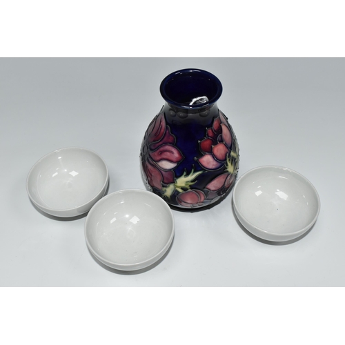 334 - A MOORCROFT POTTERY 'ANEMONE' VASE AND THREE BLANK MOORCROFT BOWLS, the baluster vase tube lined wit... 