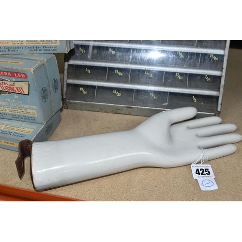 425 - A PORCELAIN HAND GLOVE MOULD, marked A.H.G, together with a shop counter display case for INTAL -hig... 