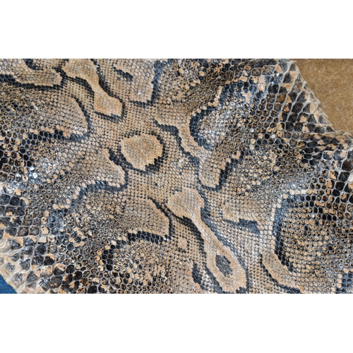 429 - A LARGE RETICULATED PYTHON SKIN, brown and cream colour, length 480cm (1) (Condition Report: signs o... 