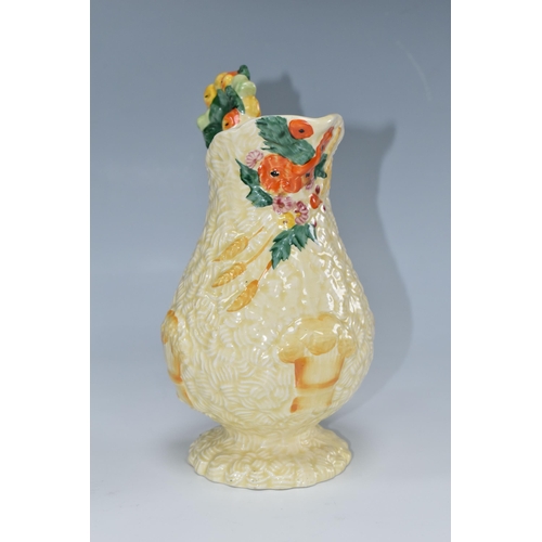 439 - A CLARICE CLIFF 'CELTIC HARVEST' JUG, moulded and painted with fruit and wheatsheaves on a textured ... 