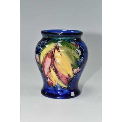 441 - A MOORCROFT POTTERY 'LEAF AND BERRY' PATTERN VASE, of small baluster form, tube lined with multicolo... 