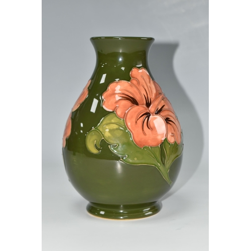 443 - A MOORCROFT POTTERY 'CORAL HIBISCUS' VASE, the baluster form vase tube lined with coral hibiscus flo... 