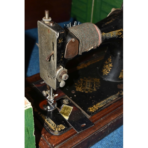 470 - TWO ANTIQUE SEWING MACHINES WITH WOODEN CASES, comprising a machine branded Faudels of London, possi... 