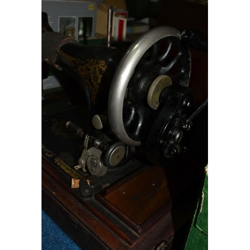 470 - TWO ANTIQUE SEWING MACHINES WITH WOODEN CASES, comprising a machine branded Faudels of London, possi... 