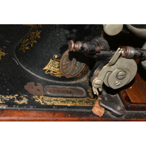 470 - TWO ANTIQUE SEWING MACHINES WITH WOODEN CASES, comprising a machine branded Faudels of London, possi... 