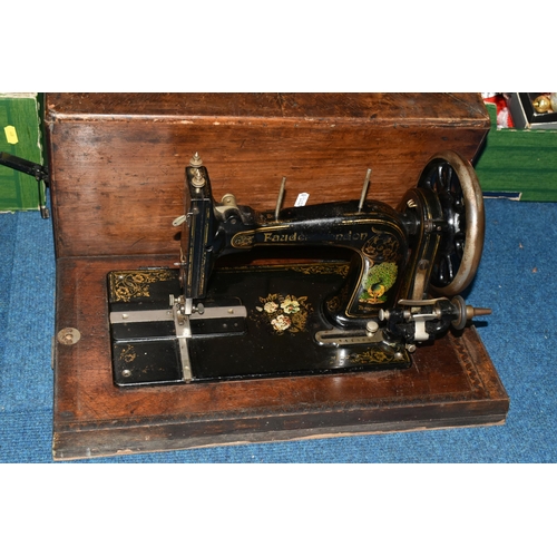 470 - TWO ANTIQUE SEWING MACHINES WITH WOODEN CASES, comprising a machine branded Faudels of London, possi... 