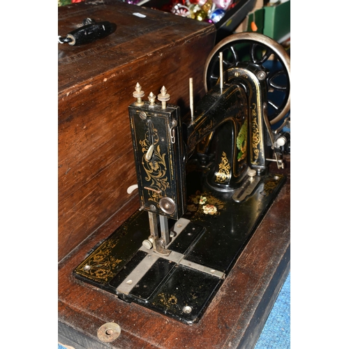 470 - TWO ANTIQUE SEWING MACHINES WITH WOODEN CASES, comprising a machine branded Faudels of London, possi... 