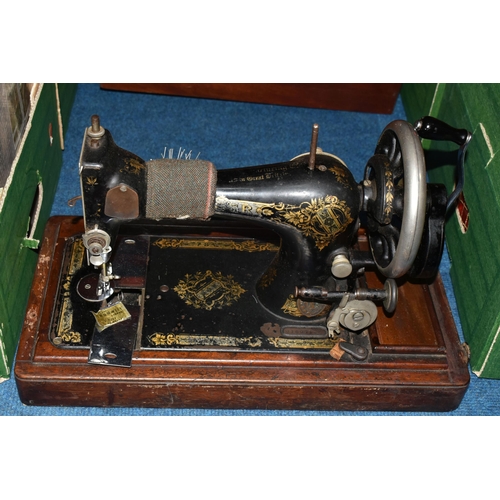 470 - TWO ANTIQUE SEWING MACHINES WITH WOODEN CASES, comprising a machine branded Faudels of London, possi... 