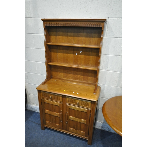 1209 - A LATE 20TH CENTURY OAK OVAL EXTENDING DINING TABLE, with one additional fold out leaf, open length ... 