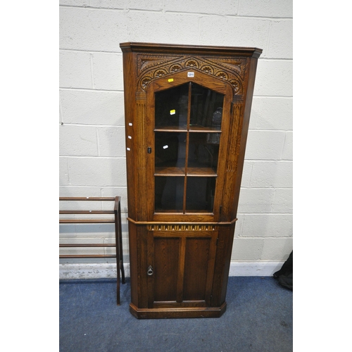 1211 - AN EARLY 20TH CENTURY OAK CORNER CUPBOARD, with a glazed door and cupboard door, an oak double door ... 