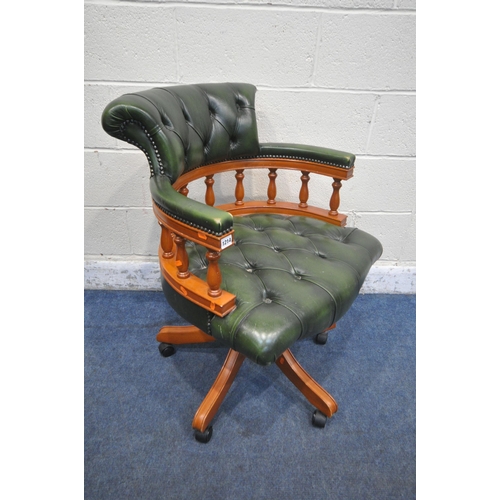 1214 - A REPRODUCTION SWIVEL OFFICE CHAIR, with buttoned green leather upholstery, raised on five shaped le... 