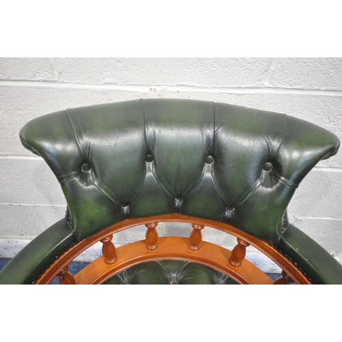 1214 - A REPRODUCTION SWIVEL OFFICE CHAIR, with buttoned green leather upholstery, raised on five shaped le... 