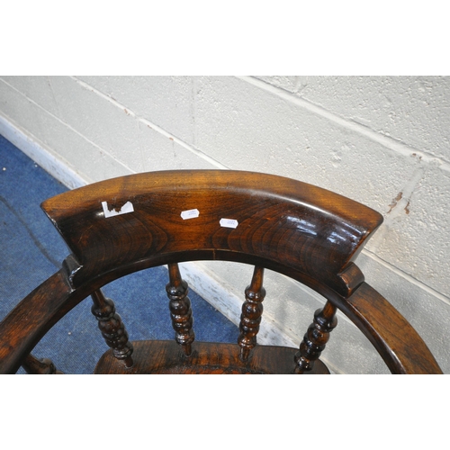 1220 - A 20TH CENTURY ELM AND BEECH BOW TOP CAPTAINS CHAIR, with shaped armrests, spindle supports, raised ... 