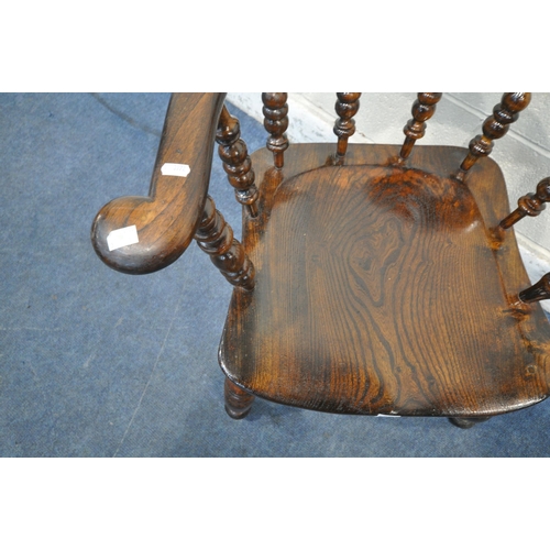 1220 - A 20TH CENTURY ELM AND BEECH BOW TOP CAPTAINS CHAIR, with shaped armrests, spindle supports, raised ... 