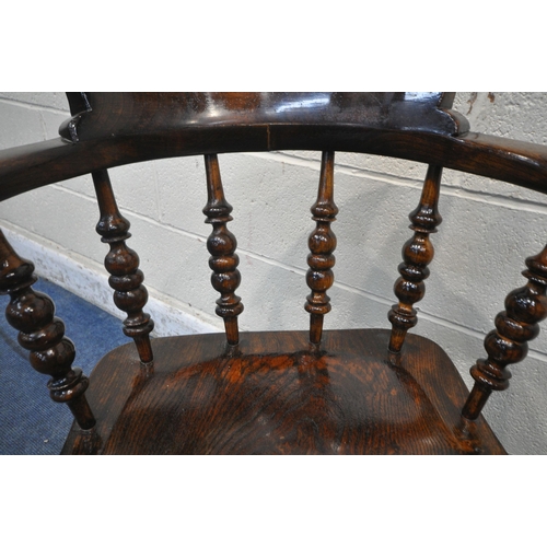 1220 - A 20TH CENTURY ELM AND BEECH BOW TOP CAPTAINS CHAIR, with shaped armrests, spindle supports, raised ... 