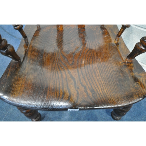 1220 - A 20TH CENTURY ELM AND BEECH BOW TOP CAPTAINS CHAIR, with shaped armrests, spindle supports, raised ... 