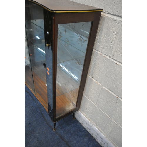 1244 - A MID CENTURY TEAK EFFECT DISPLAY CABINET, with two mirror panes, flanking double glass sliding door... 