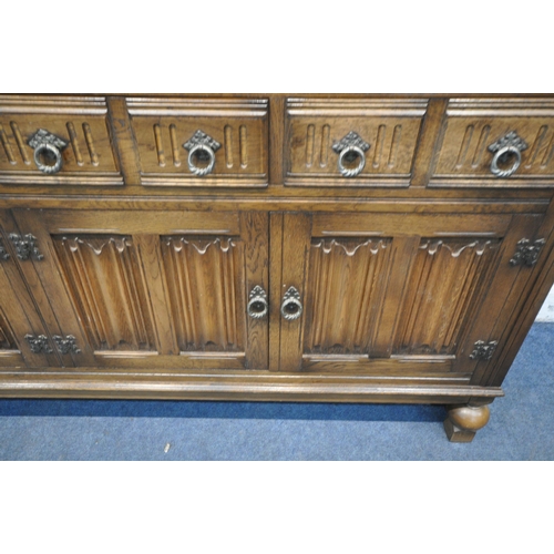 1254 - A 20TH CENTURY OAK SIDEBOARD, fitted with four drawers, above four linenfold cupboard doors, raised ... 