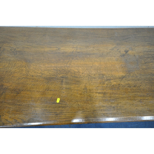 1255 - A 20TH CENTURY OAK TABLE, the two inch rectangular top, raised on bulbous carved supports, shaped le... 