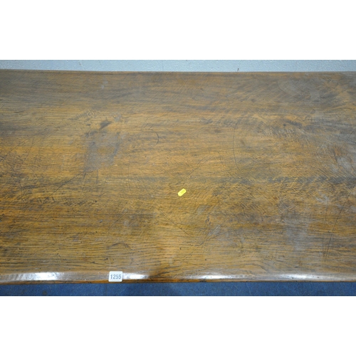 1255 - A 20TH CENTURY OAK TABLE, the two inch rectangular top, raised on bulbous carved supports, shaped le... 