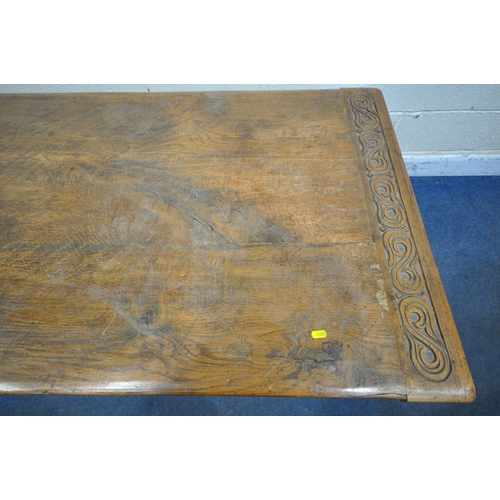 1255 - A 20TH CENTURY OAK TABLE, the two inch rectangular top, raised on bulbous carved supports, shaped le... 