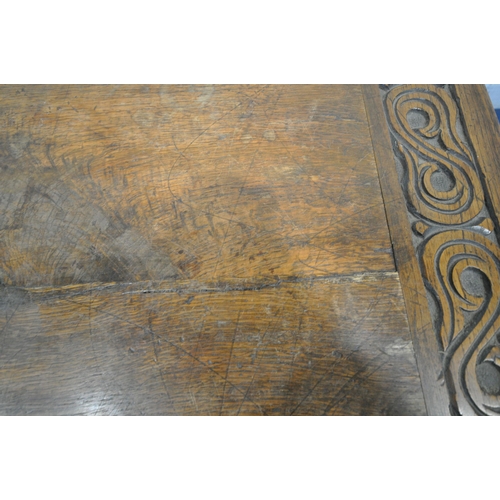 1255 - A 20TH CENTURY OAK TABLE, the two inch rectangular top, raised on bulbous carved supports, shaped le... 