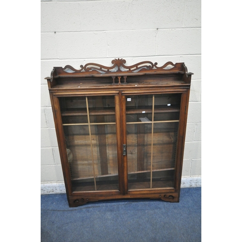 1256 - AN EARLY 20TH CENTURY OAK BOOKCASE, with raised back, double glazed doors, enclosing three shelves, ... 