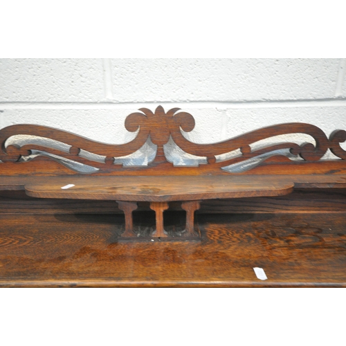 1256 - AN EARLY 20TH CENTURY OAK BOOKCASE, with raised back, double glazed doors, enclosing three shelves, ... 